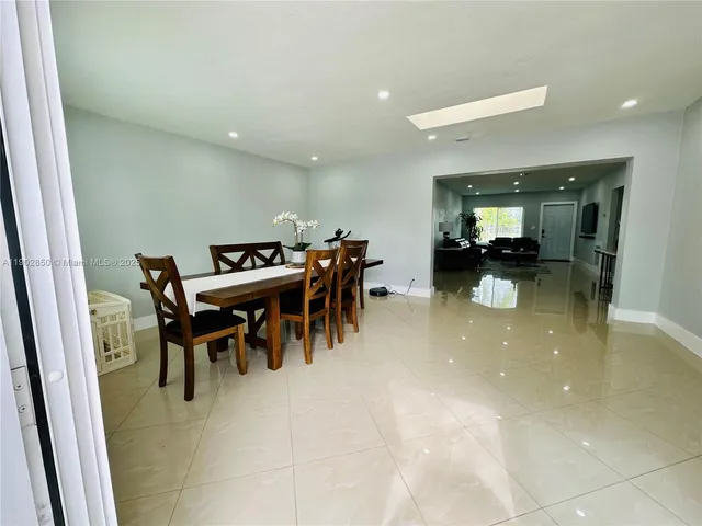 a view of a dining area with furniture and chandelier