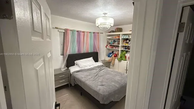 a bedroom with a bed and a mirror in it