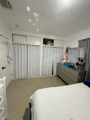 a bedroom with a bed and a closet