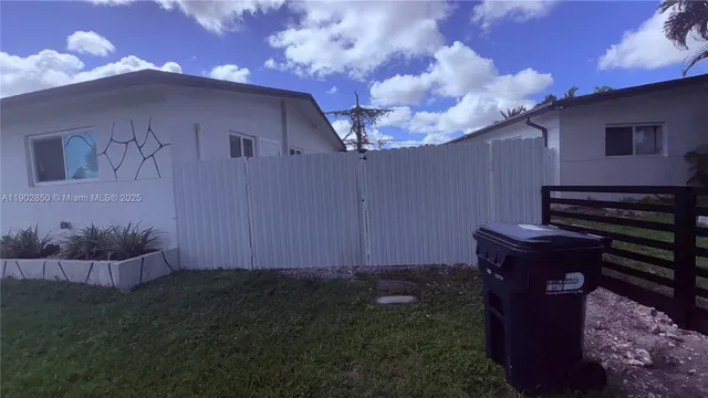 a backyard of a house with wooden fence