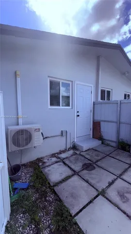 a bedroom with a rug and a window