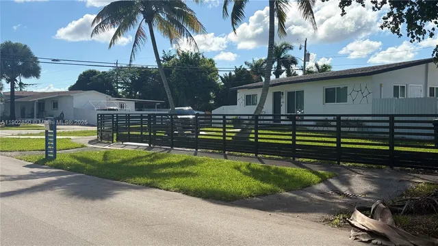 a view of a house with swimming pool and a yard