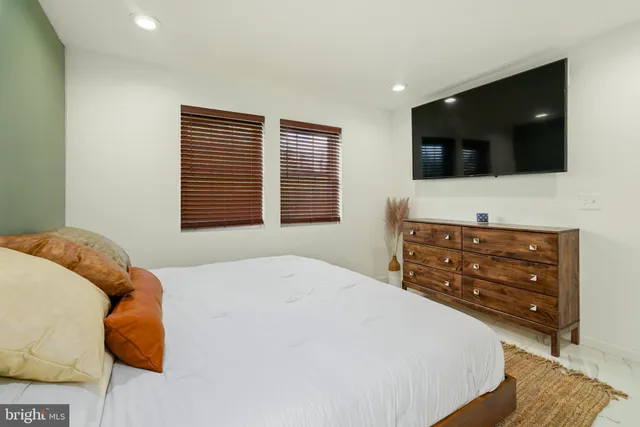 a living room with a large bed and a couch