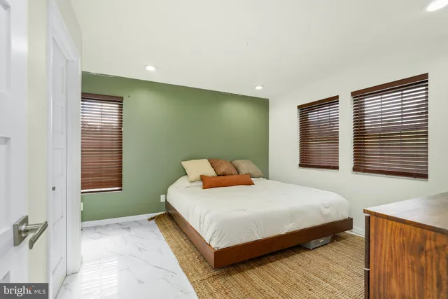 a bedroom with a bed and a television