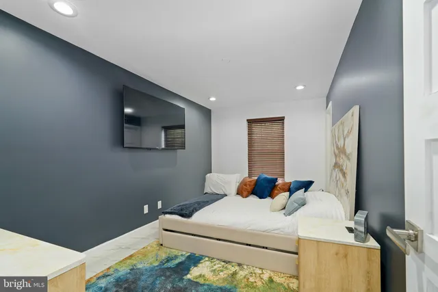 a view of an outdoor kitchen with a table and chairs