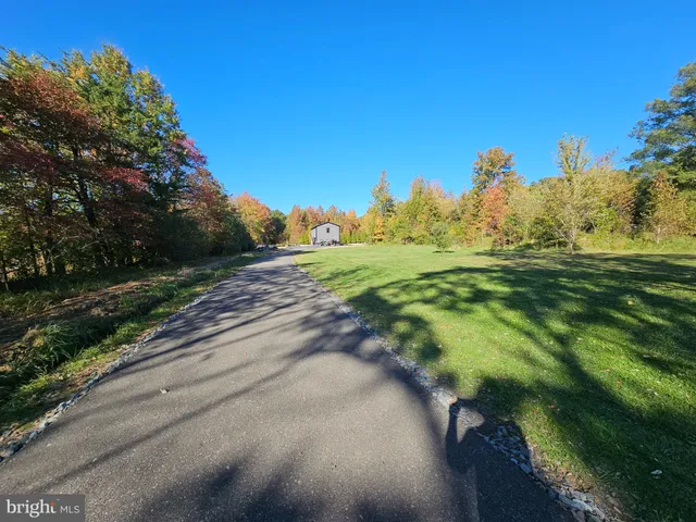 a view of a green field with wooden fence