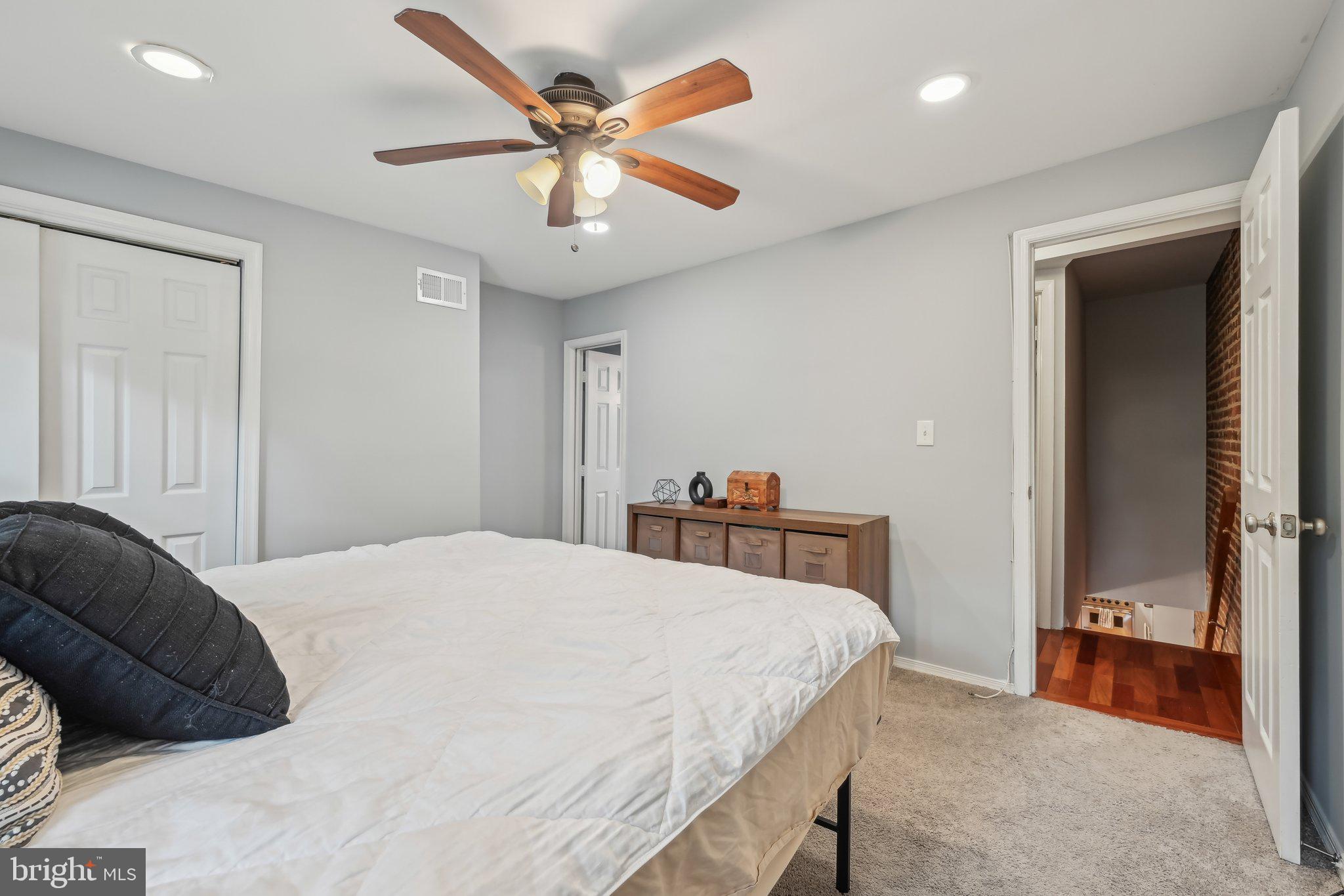 935 South Kenwood Avenue Baltimore, MD 21224 - Photo 12 of 25 a bedroom with a bed and a chandelier