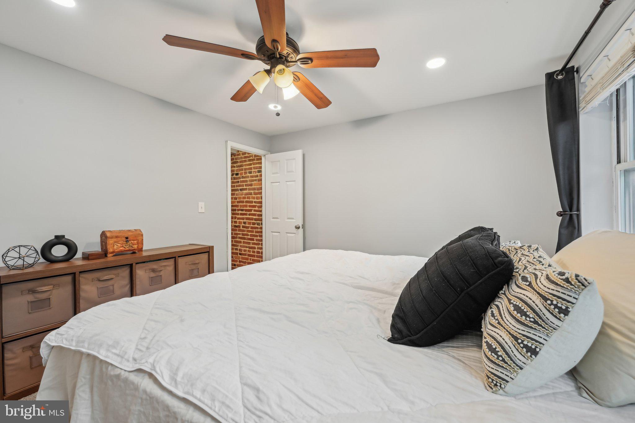 935 South Kenwood Avenue Baltimore, MD 21224 - Photo 13 of 25 a bedroom with a bed and a chandelier
