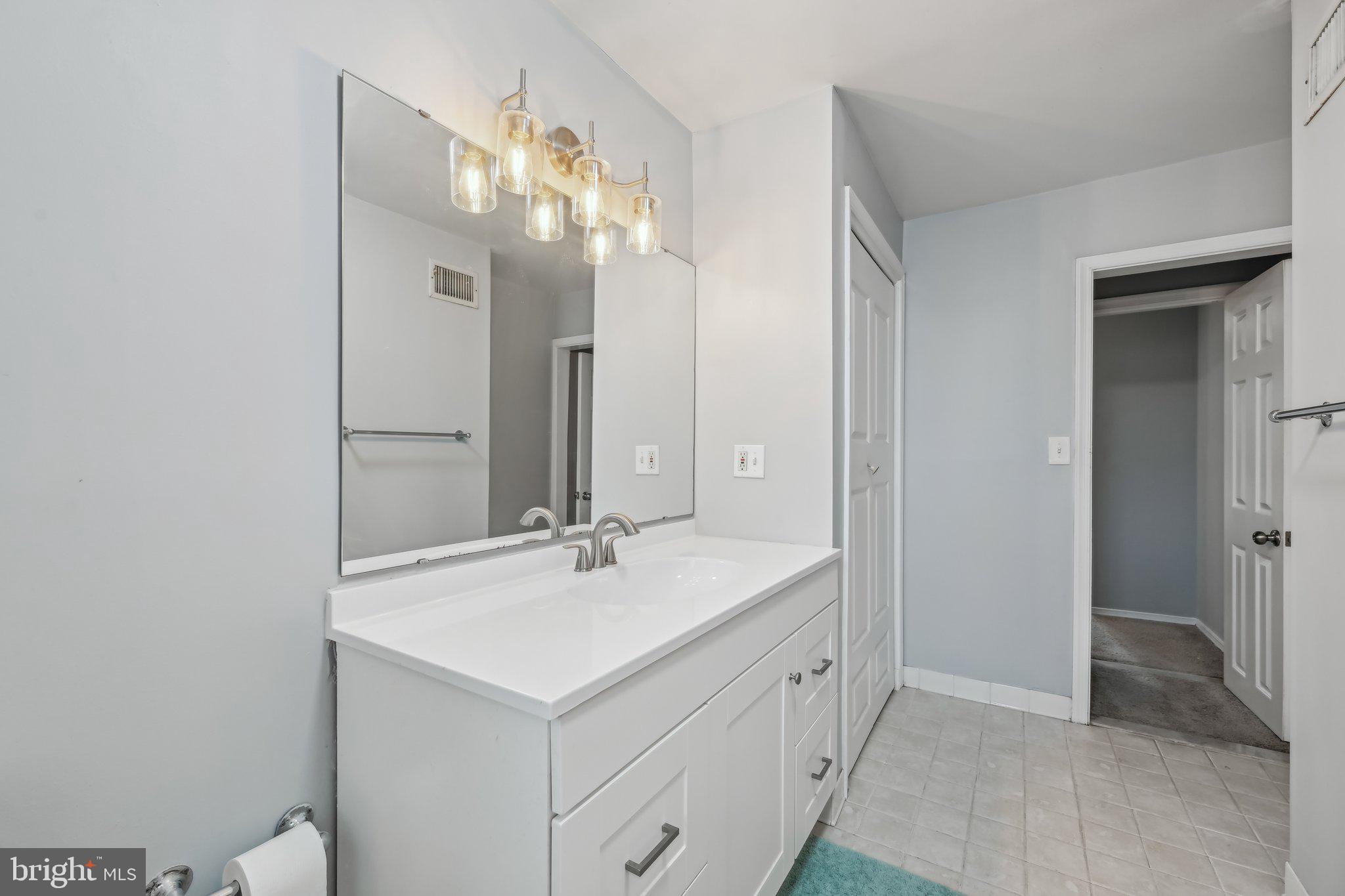 935 South Kenwood Avenue Baltimore, MD 21224 - Photo 15 of 25 a bathroom with a sink vanity tub and shower
