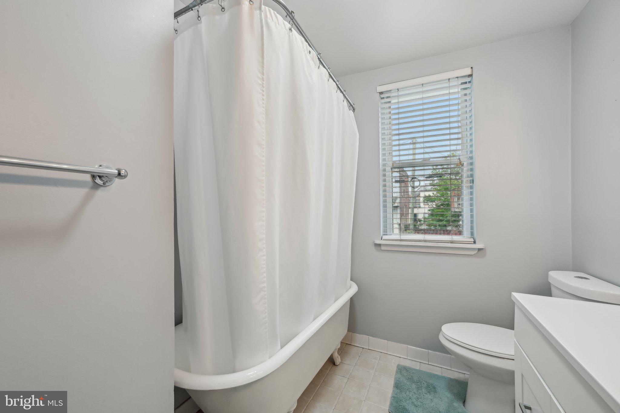 935 South Kenwood Avenue Baltimore, MD 21224 - Photo 16 of 25 a bathroom with a sink a toilet and shower