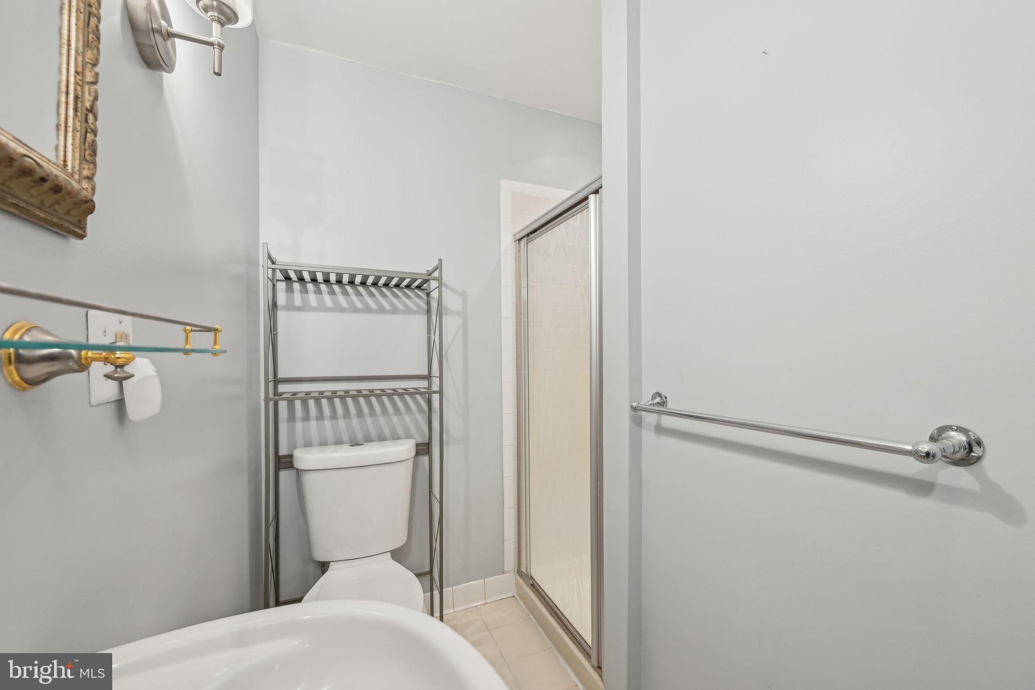 935 South Kenwood Avenue Baltimore, MD 21224 - Photo 17 of 25 a bathroom with a toilet and a shower