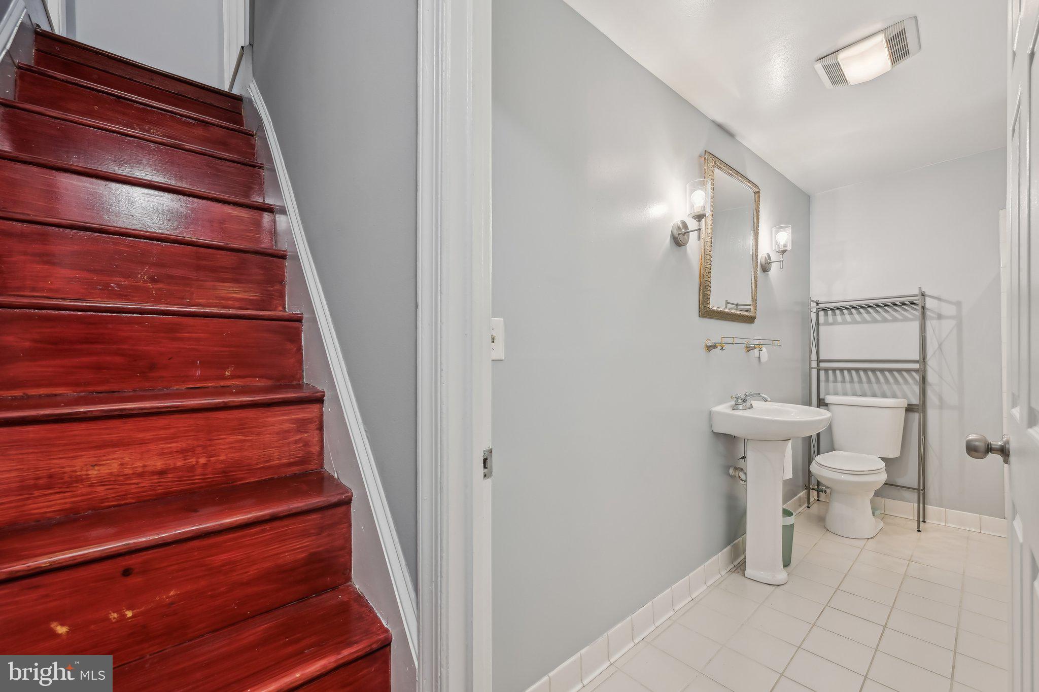 935 South Kenwood Avenue Baltimore, MD 21224 - Photo 19 of 25 a bathroom with a toilet and a sink