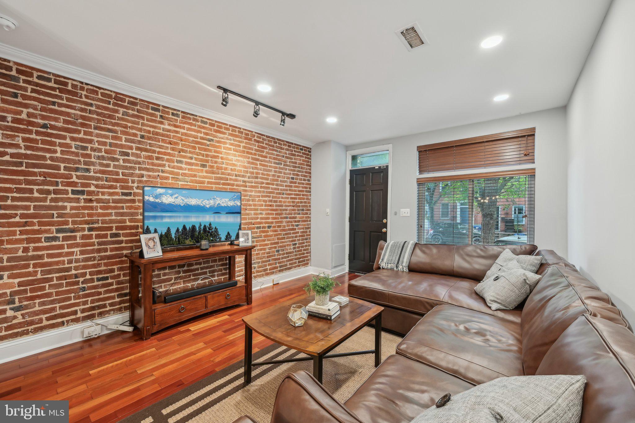 935 South Kenwood Avenue Baltimore, MD 21224 - Photo 2 of 25 a living room with furniture and a flat screen tv