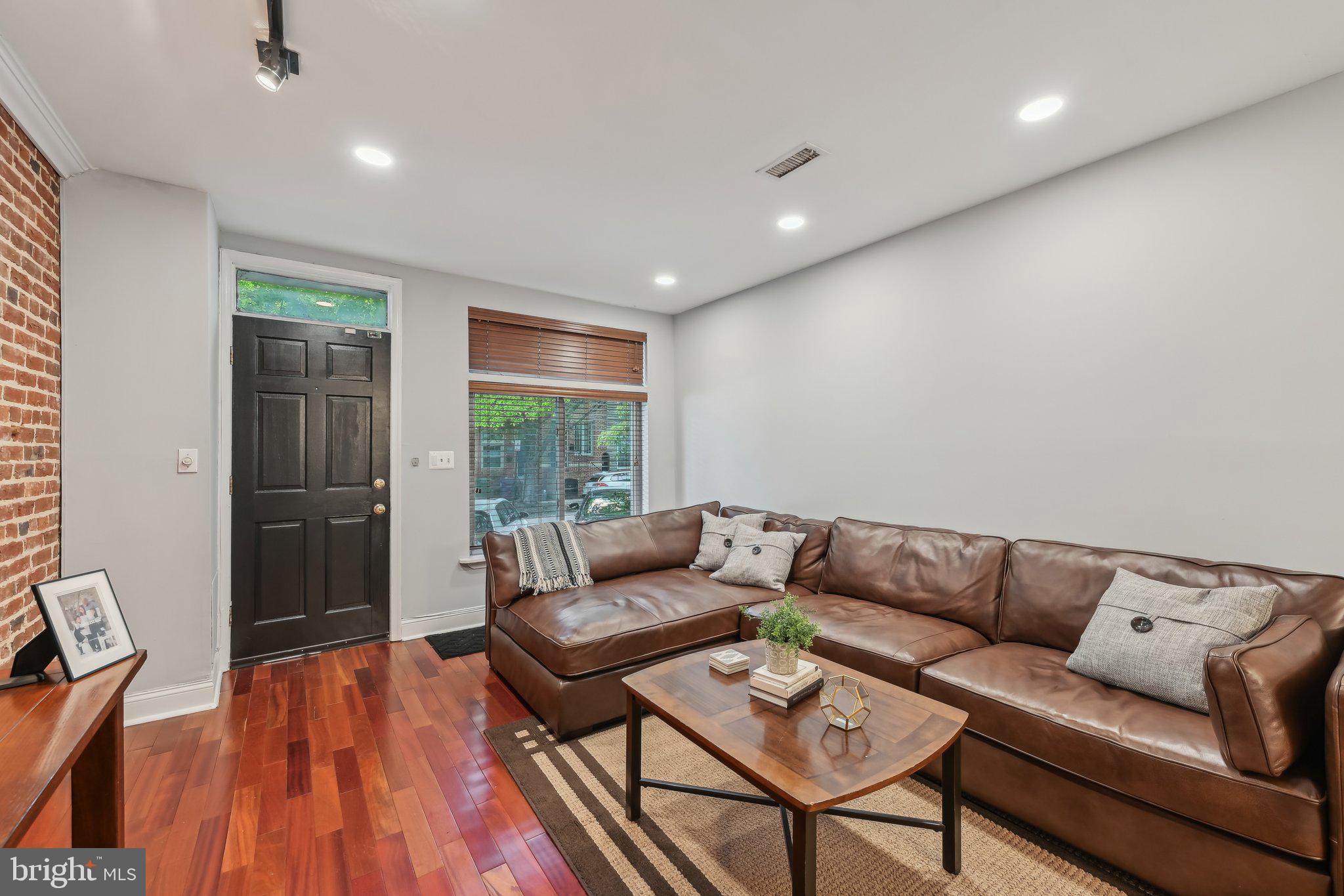 935 South Kenwood Avenue Baltimore, MD 21224 - Photo 3 of 25 a living room with furniture and a wooden floor