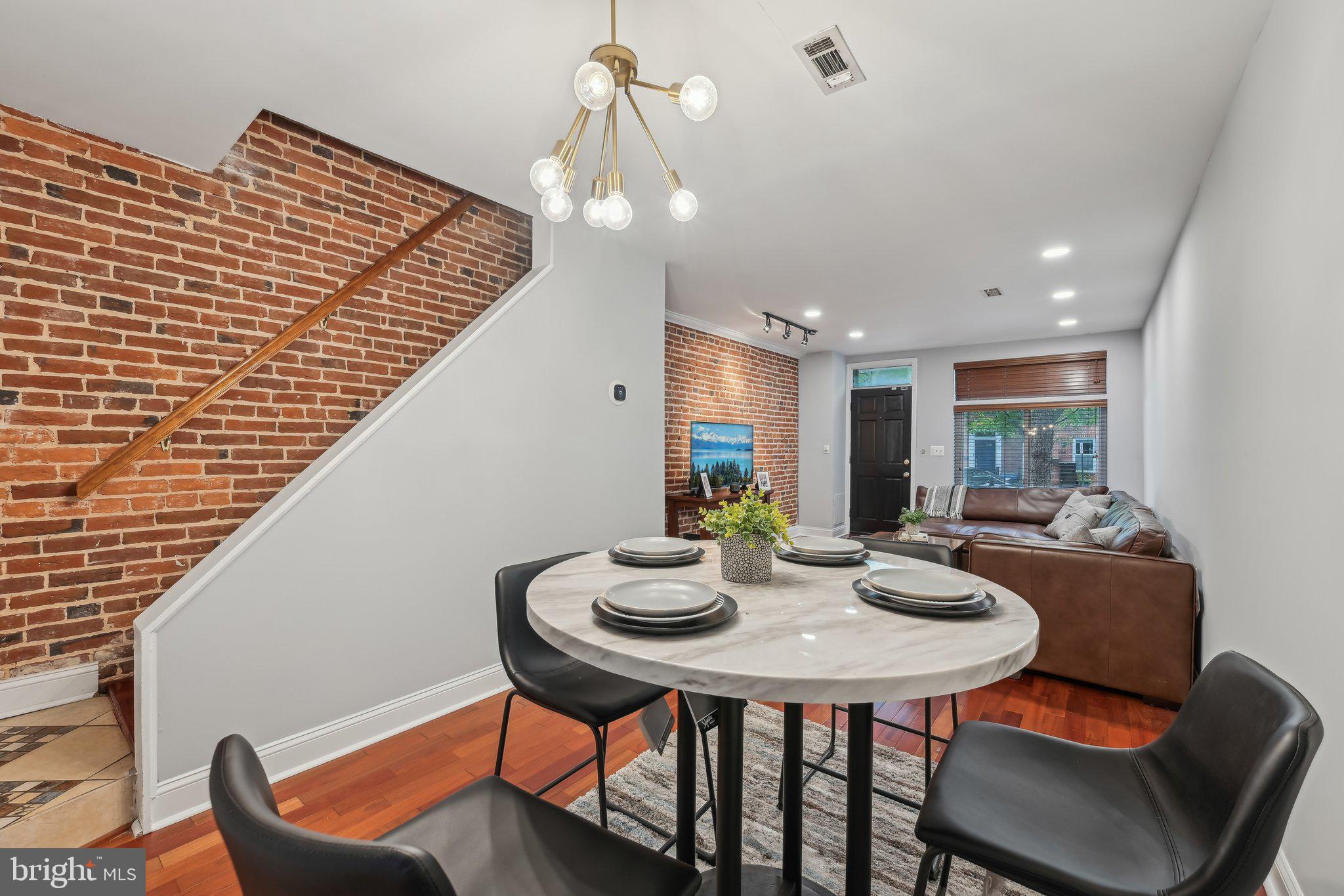 935 South Kenwood Avenue Baltimore, MD 21224 - Photo 5 of 25 a view of a dining room with furniture and wooden floor