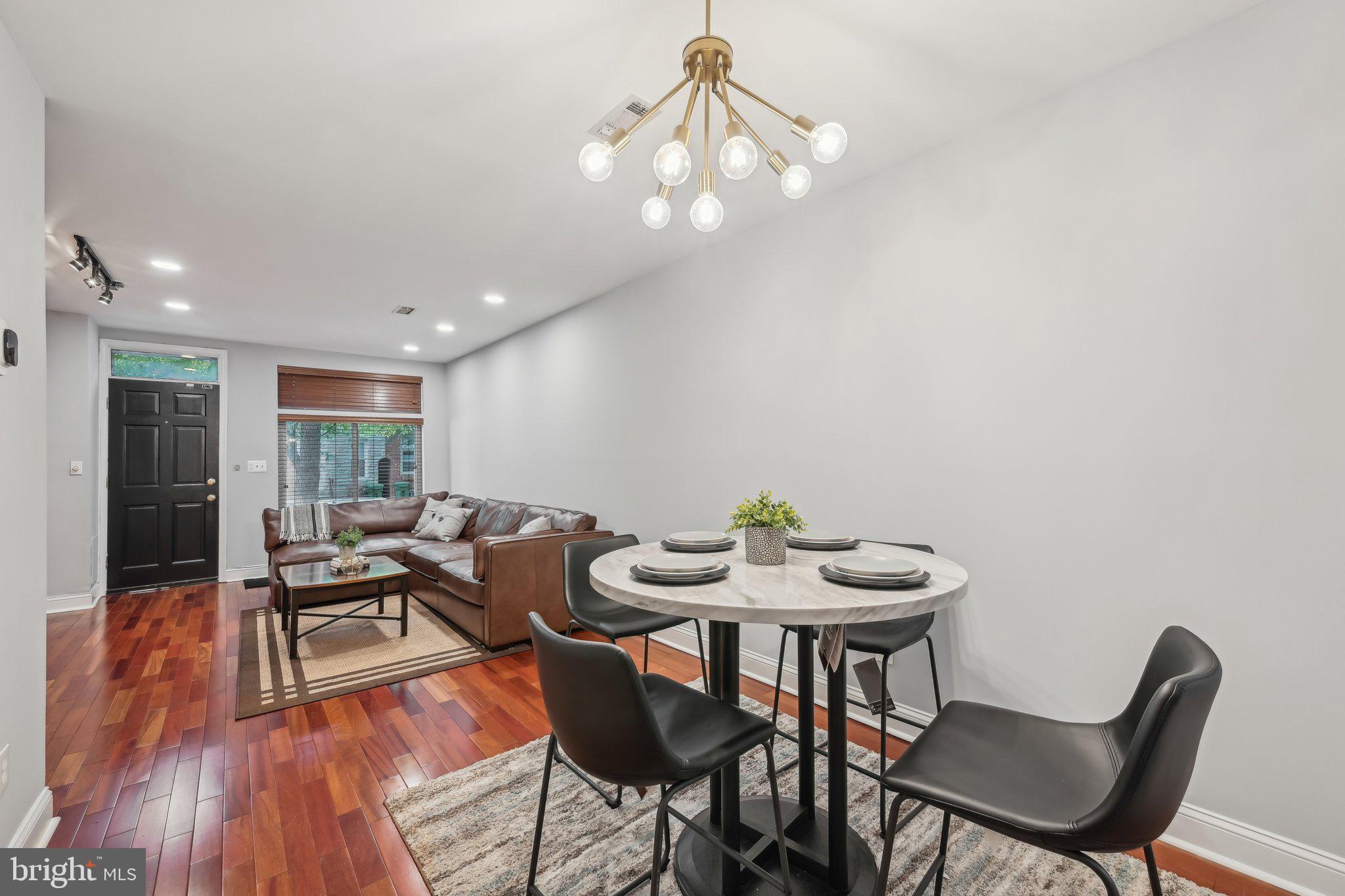 935 South Kenwood Avenue Baltimore, MD 21224 - Photo 6 of 25 a view of a dining room with furniture and wooden floor