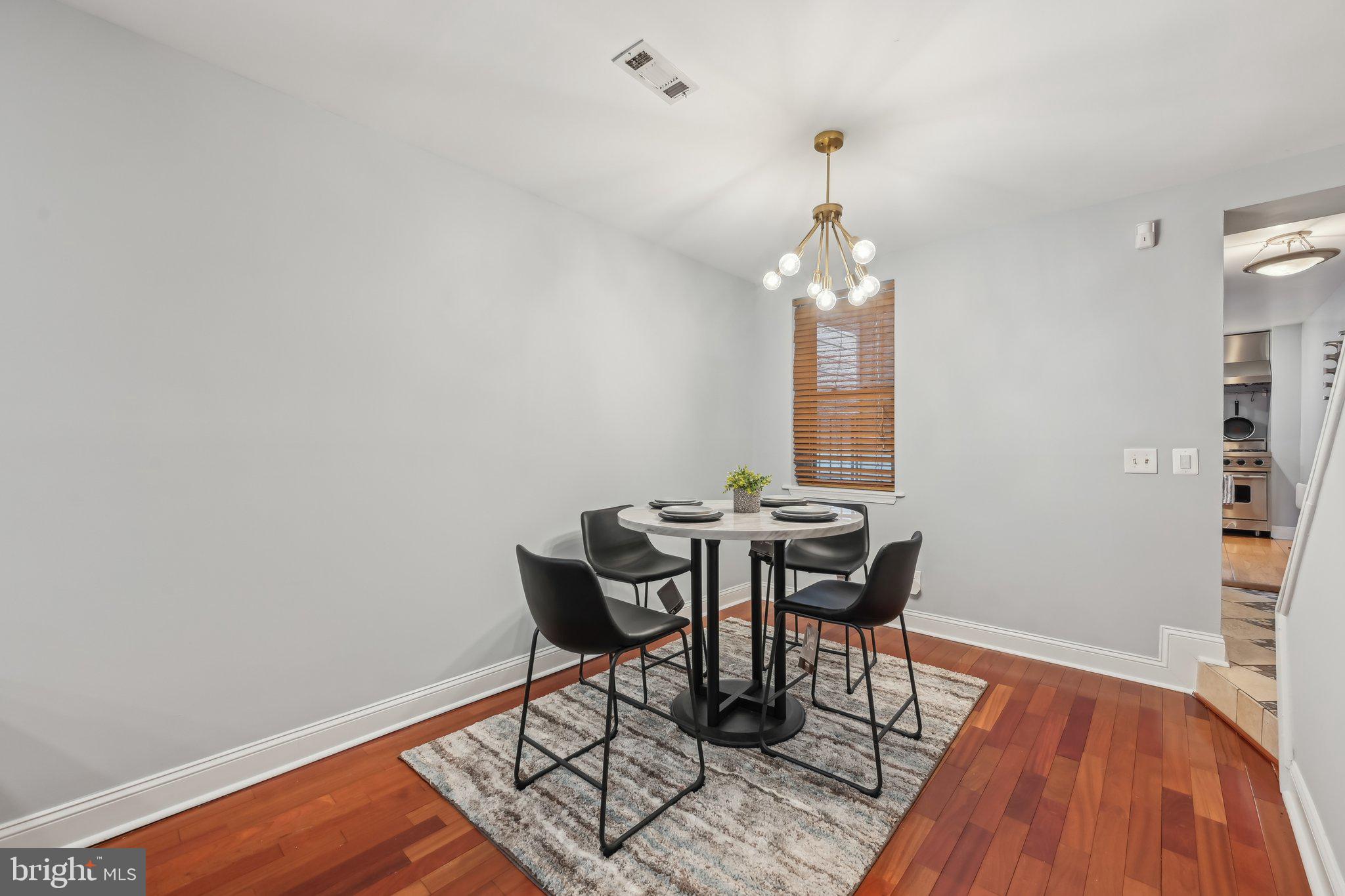 935 South Kenwood Avenue Baltimore, MD 21224 - Photo 7 of 25 a view of a dining room with furniture and wooden floor