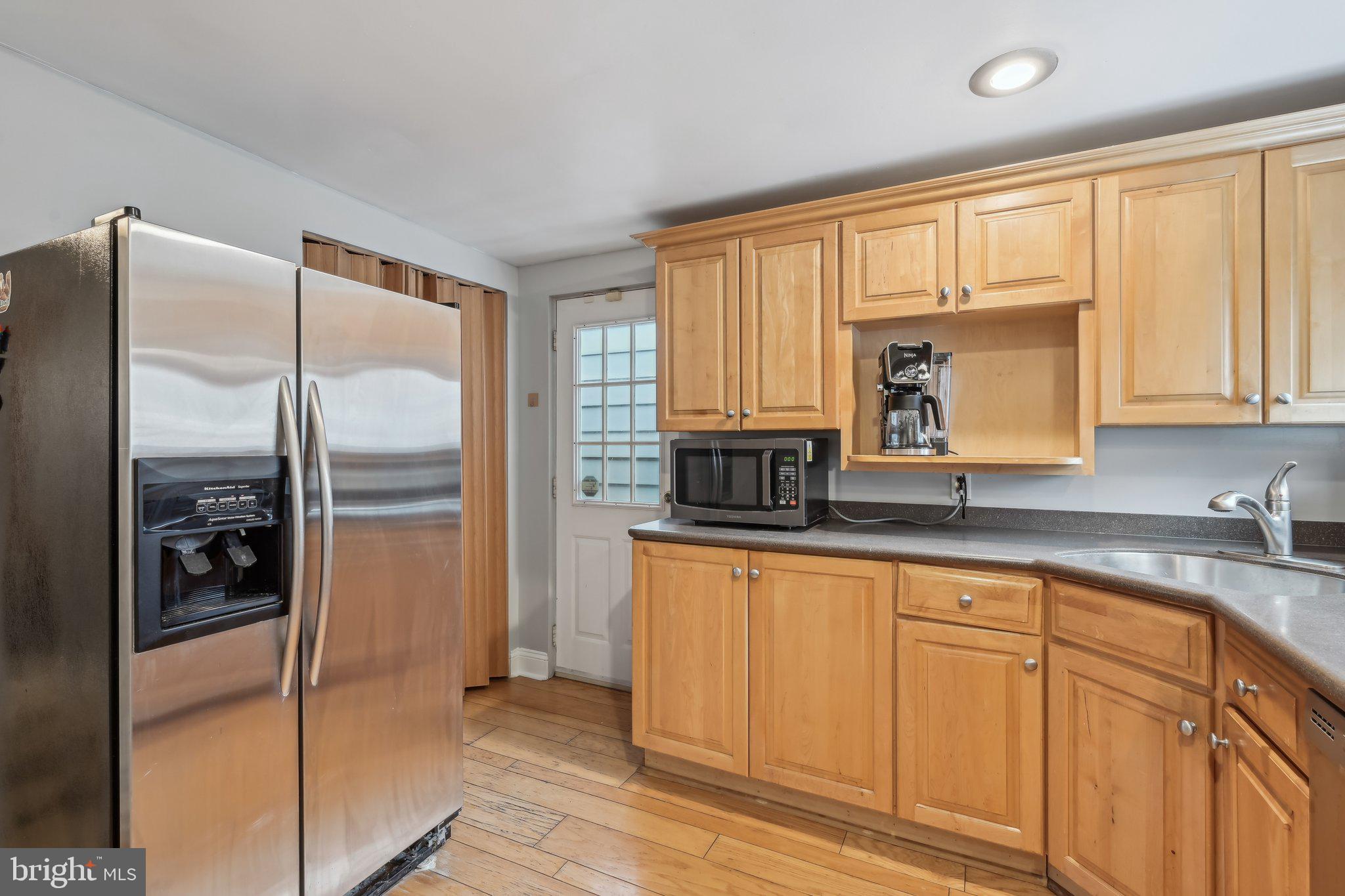 935 South Kenwood Avenue Baltimore, MD 21224 - Photo 9 of 25 a kitchen with stainless steel appliances granite countertop a refrigerator and cabinets