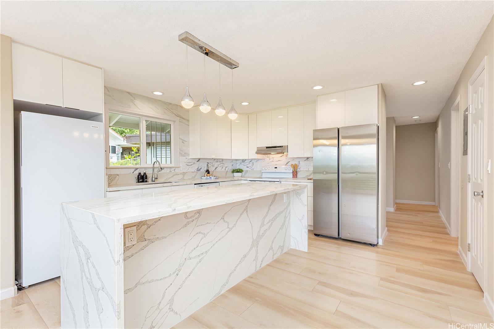 1898 Iwi Way Honolulu, HI 96816 - Photo 4 of 25 a large white kitchen with a refrigerator a oven and a sink
