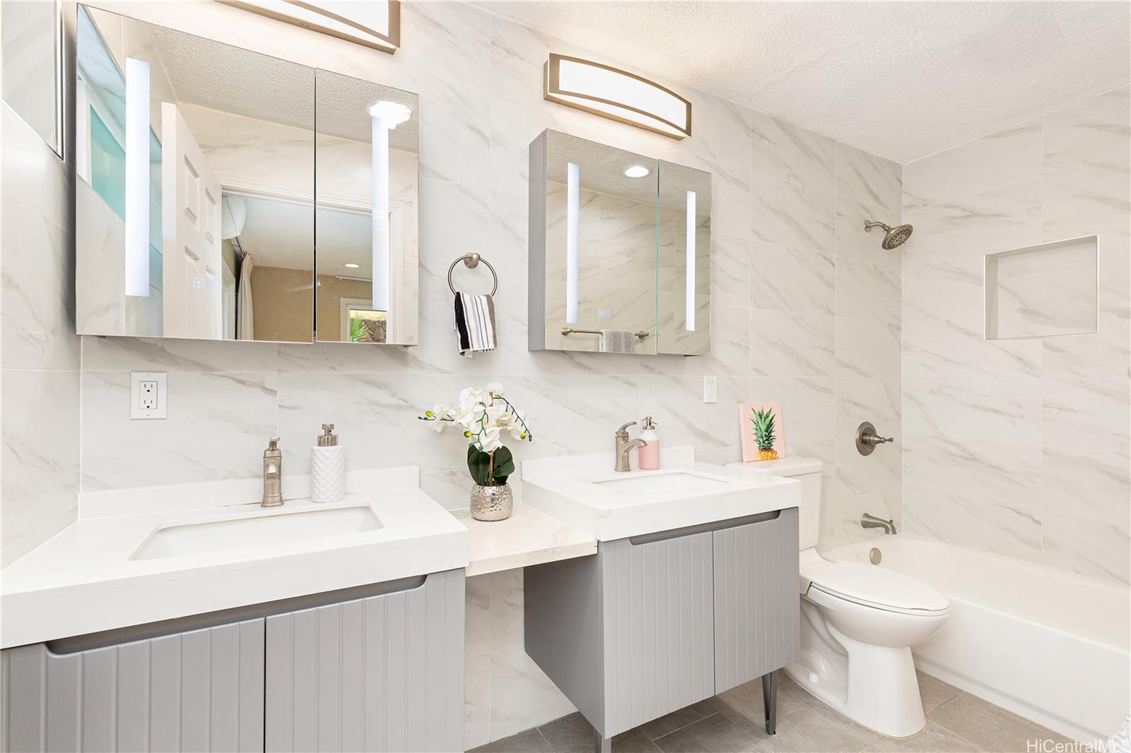 1898 Iwi Way Honolulu, HI 96816 - Photo 10 of 25 a bathroom with a double vanity sink mirror double toilet and bathtub