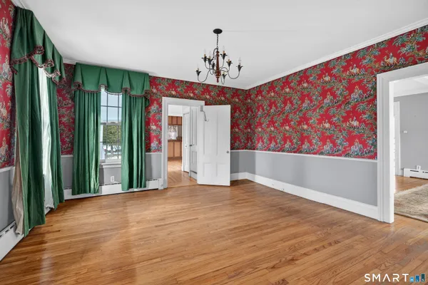 a view of an empty room with a fireplace and a large window
