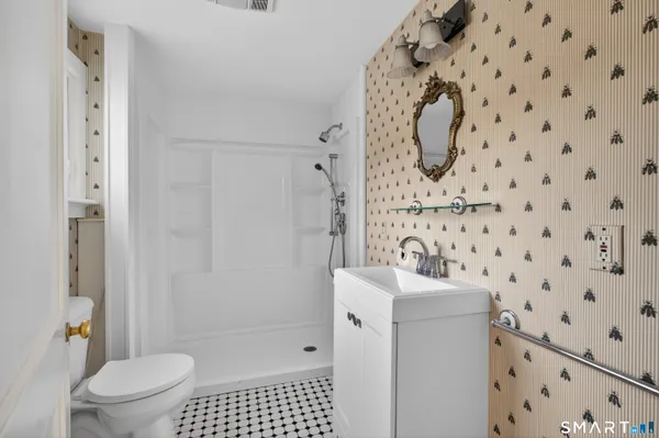 a bathroom with a sink toilet and shower