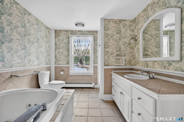 a bathroom with a bathtub sink and toilet