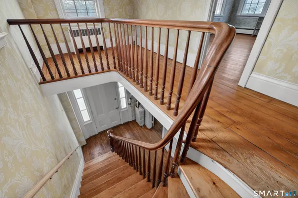 a view of staircase with railing and white walls