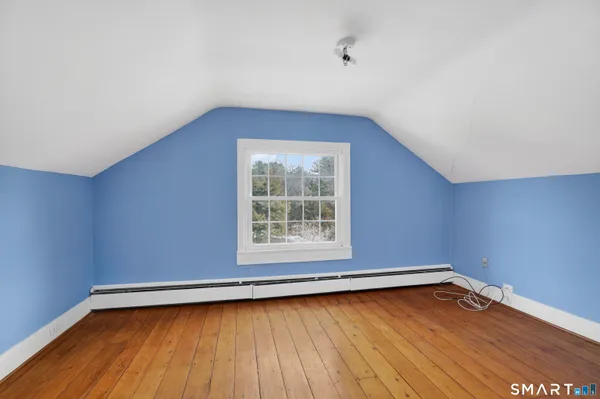 a view of a room with wooden floor and window