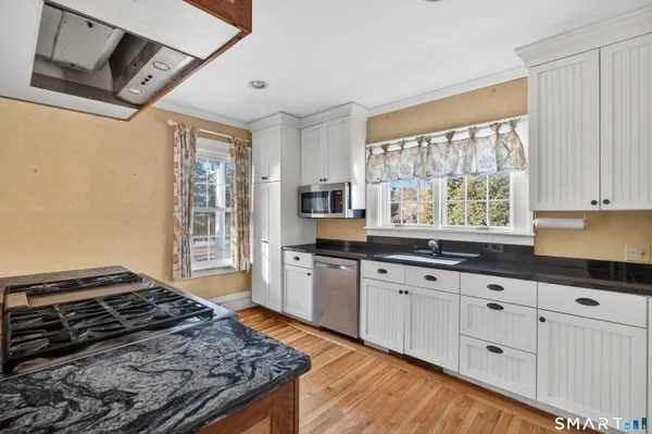a kitchen with granite countertop a stove and a sink