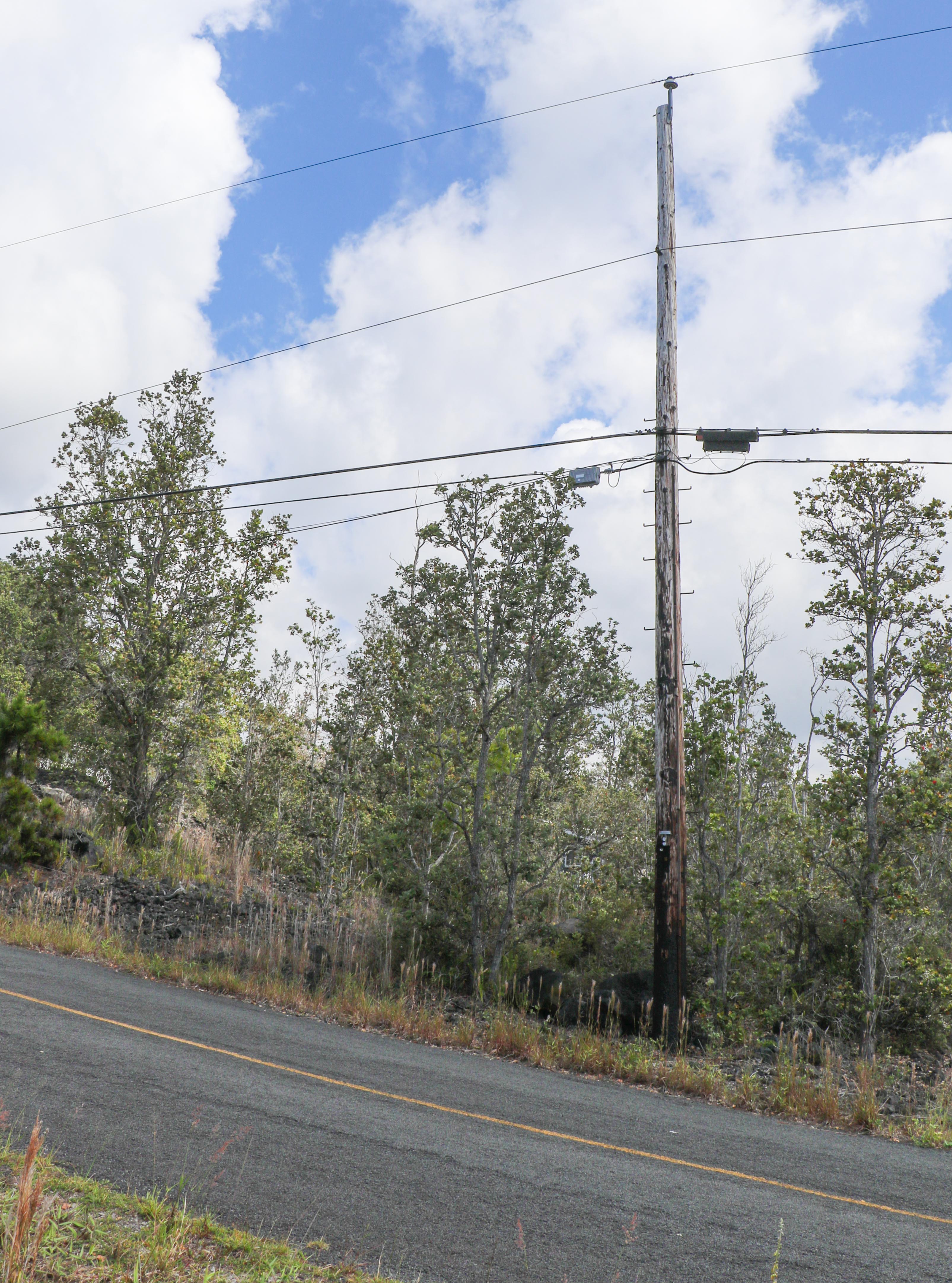92-9079 Lot 16 Ginger Blossom Lane Ocean View, HI 96704 - Photo 4 of 6 a small yard with trees in the background