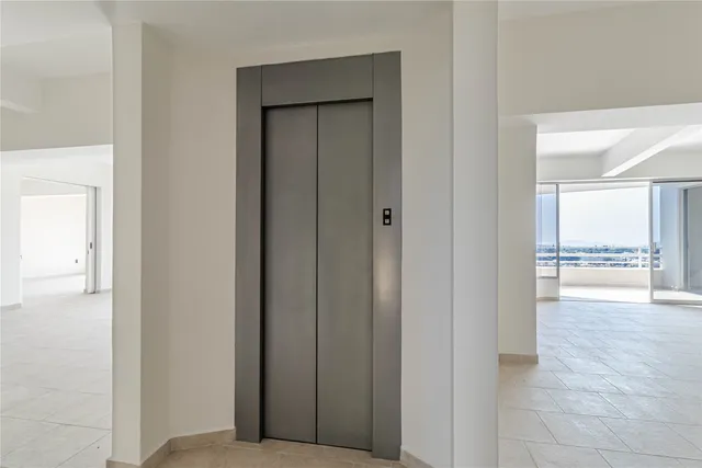 a view of swimming pool with lawn chairs and a table and chairs