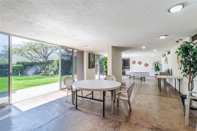 a front view of a building with trees