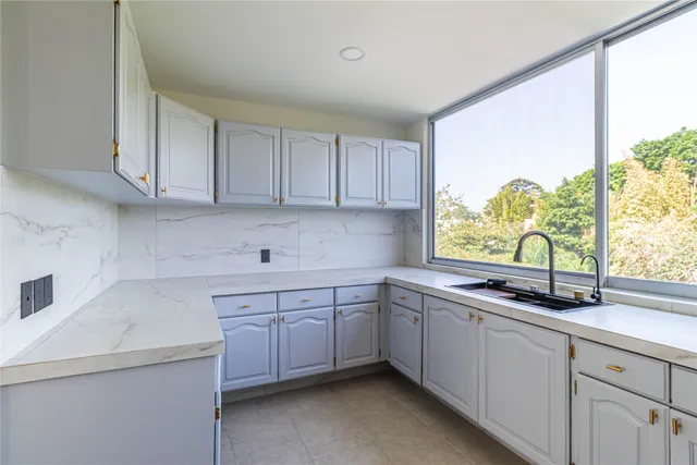 a kitchen with a sink and large window