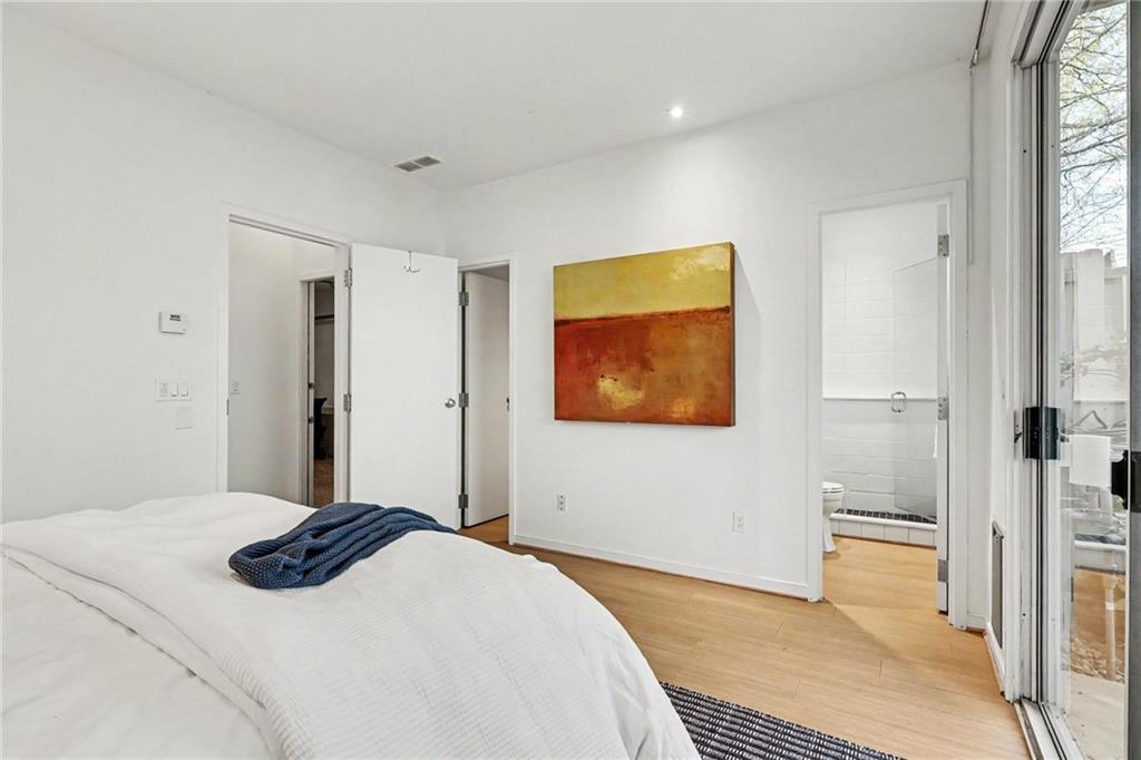 2465 Field Way Atlanta, GA 30319 - Photo 17 of 40 a bedroom with a bed and a painting on the wall