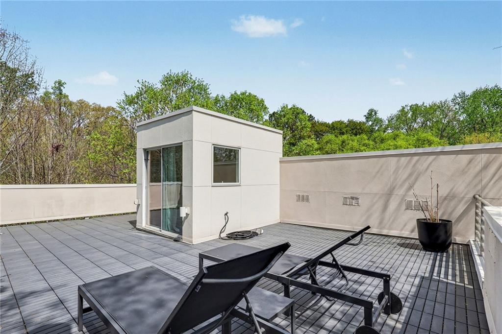 2465 Field Way Atlanta, GA 30319 - Photo 30 of 40 a view of a patio with table and chairs with wooden floor and fence
