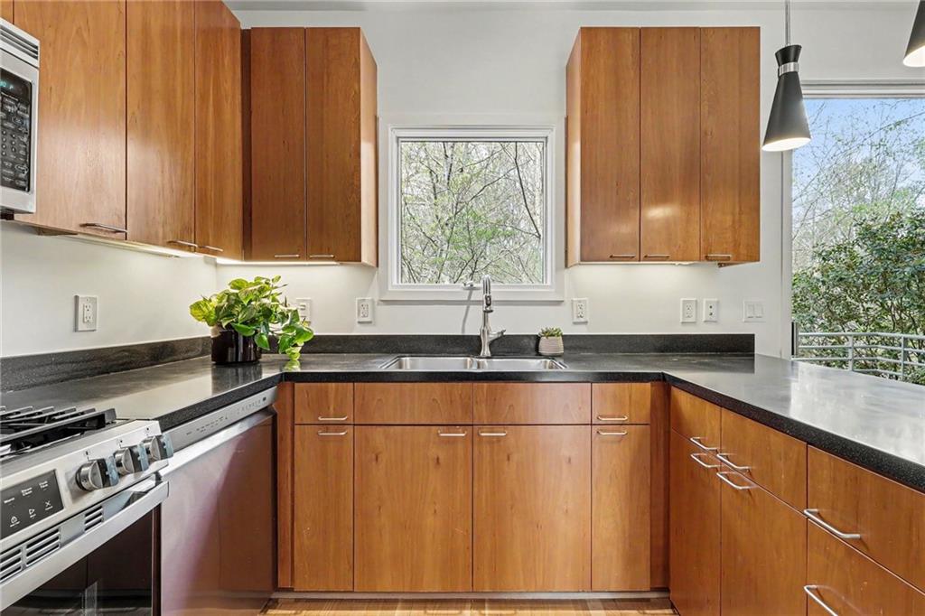 2465 Field Way Atlanta, GA 30319 - Photo 8 of 40 a kitchen with stainless steel appliances granite countertop wooden cabinets a sink and a large window