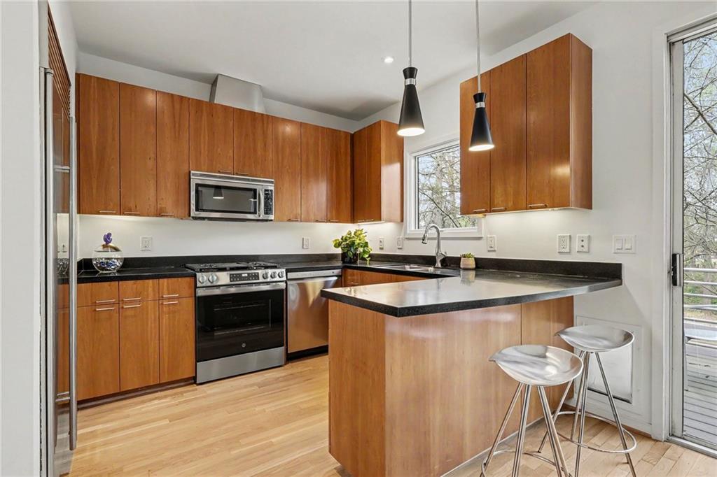 2465 Field Way Atlanta, GA 30319 - Photo 9 of 40 a kitchen with stainless steel appliances granite countertop a stove a sink and a microwave