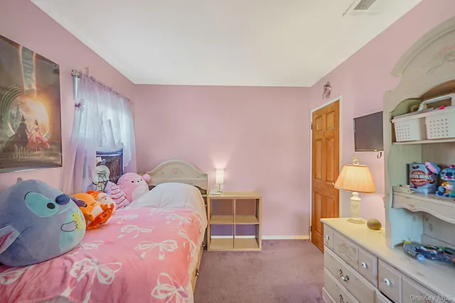 a bedroom with a bed and a dresser in it