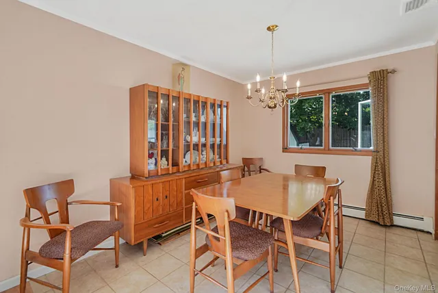 a dining room with furniture a chandelier and window