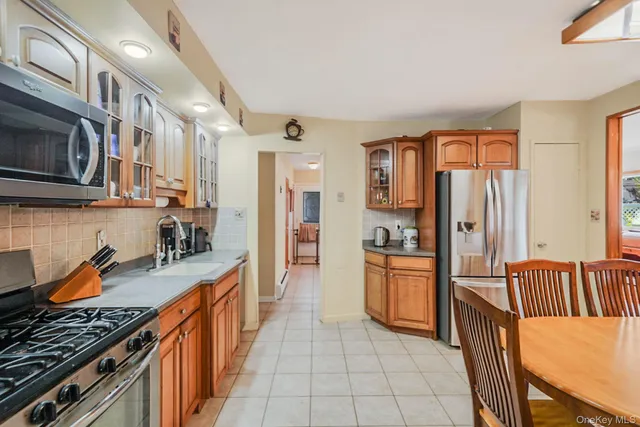 a kitchen with stainless steel appliances granite countertop a refrigerator and a stove top oven