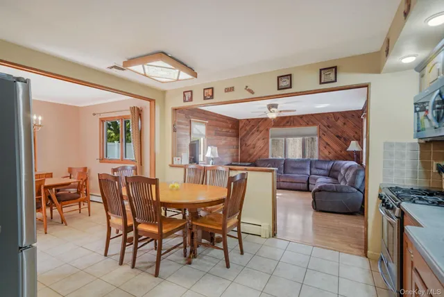 a view of a dining room with furniture and chandelier