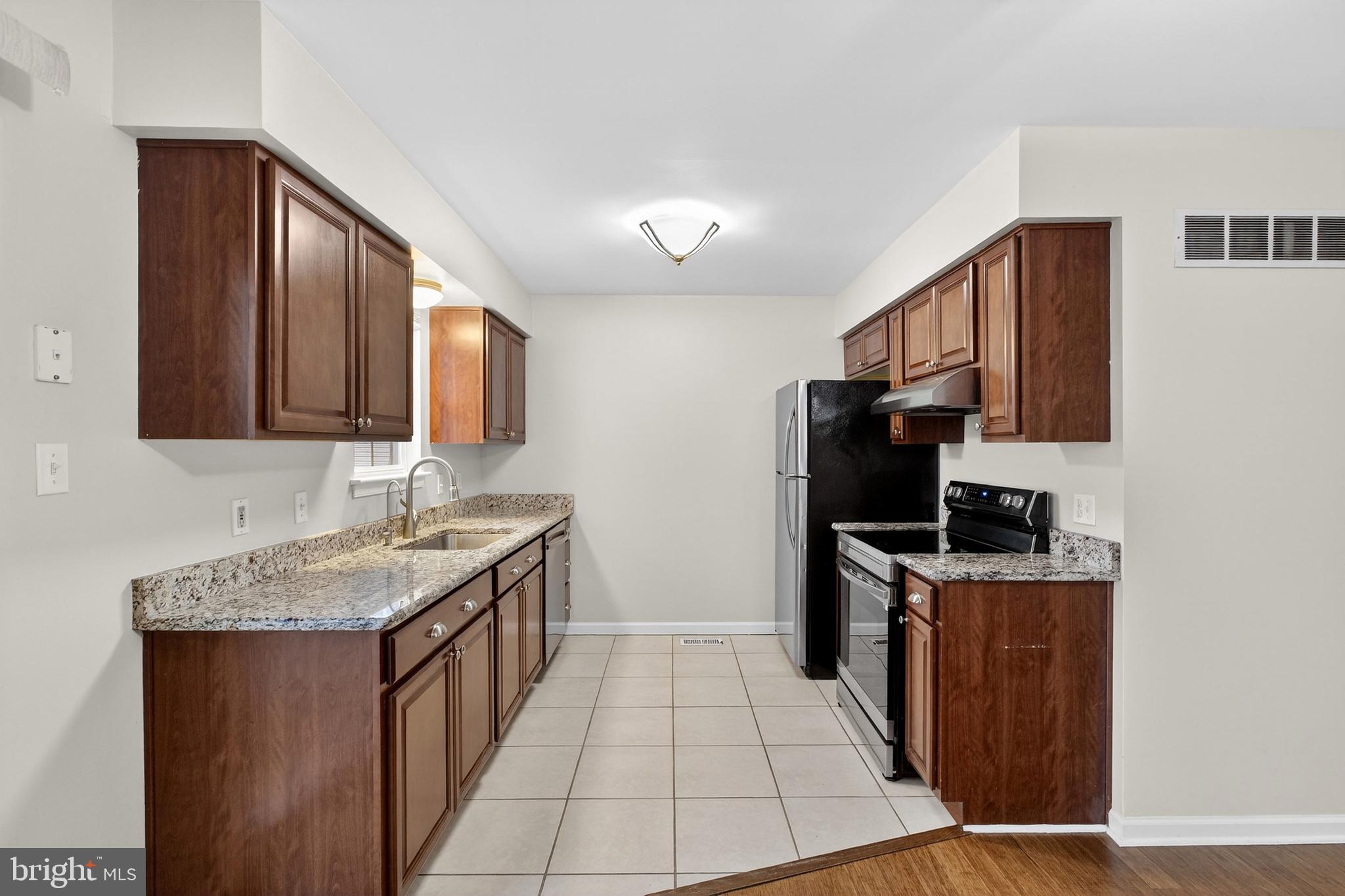 613 Candlestick Lane Newark, DE 19702 - Photo 11 of 33 a kitchen with stainless steel appliances granite countertop a refrigerator stove and sink