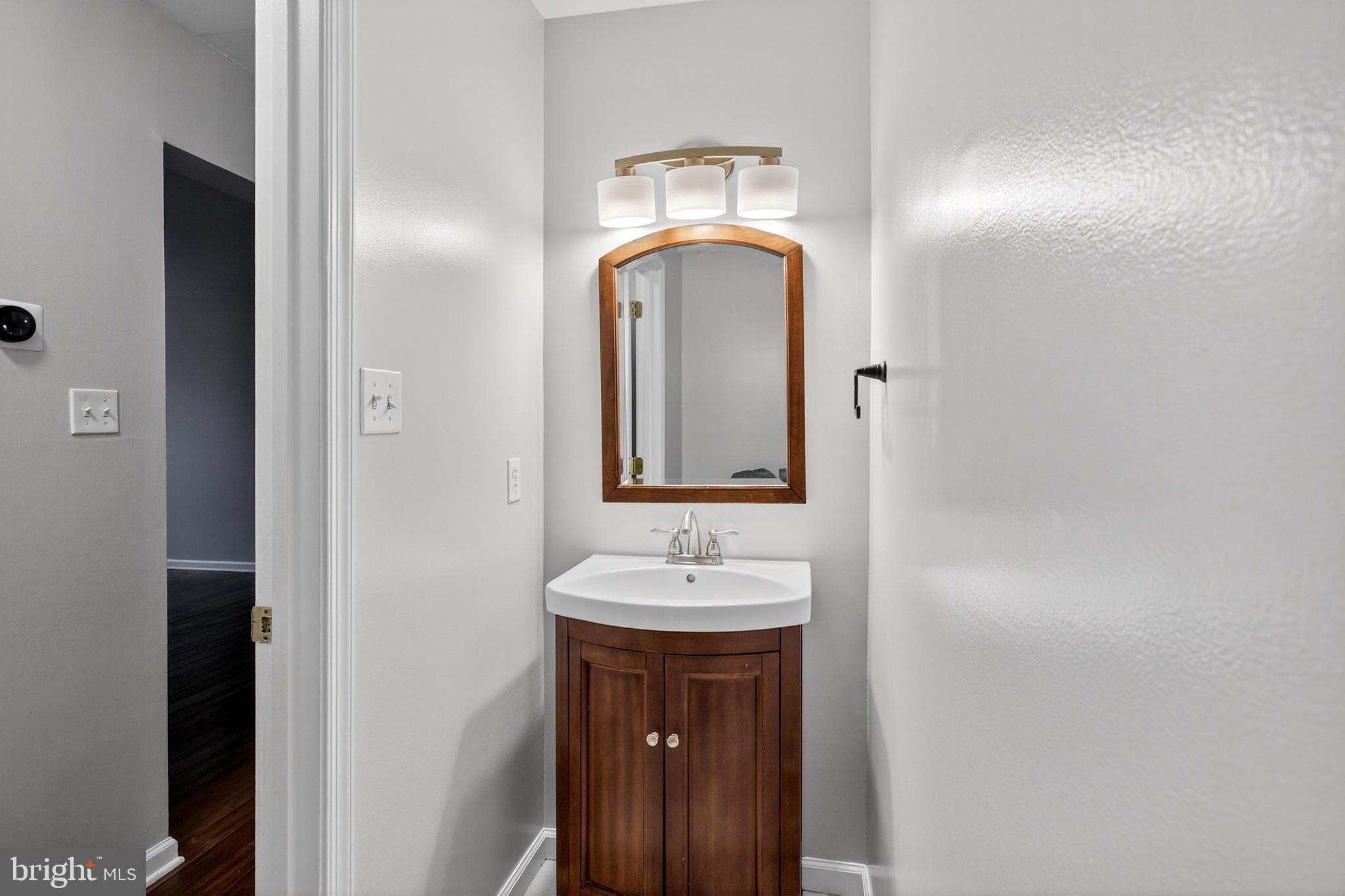 613 Candlestick Lane Newark, DE 19702 - Photo 13 of 33 a bathroom with a sink and a mirror