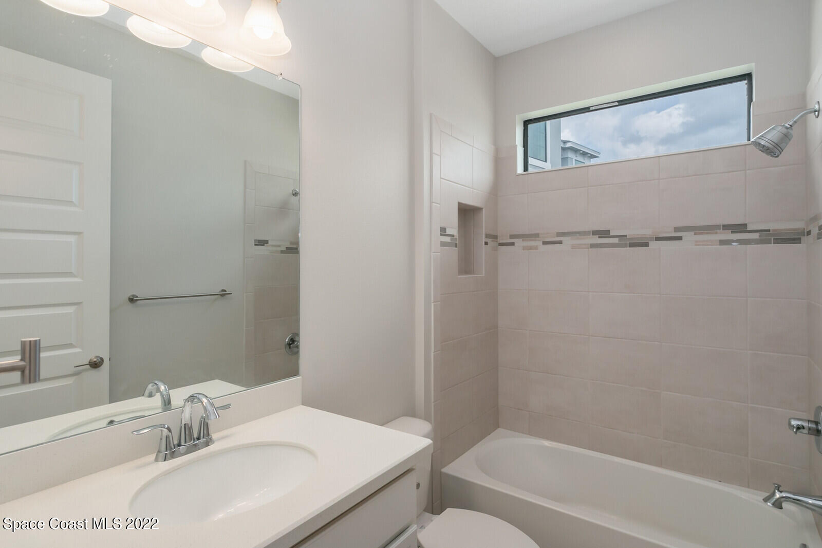 3289 Ribbon Grass Drive Melbourne, FL 32940 - Photo 14 of 58 a bathroom with a sink toilet and shower