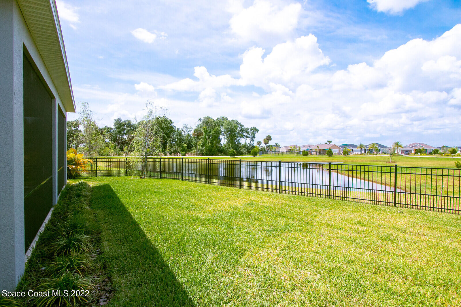 3289 Ribbon Grass Drive Melbourne, FL 32940 - Photo 20 of 58 a view of a yard with swimming pool and green space