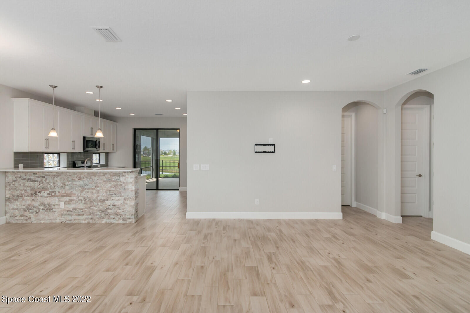 3289 Ribbon Grass Drive Melbourne, FL 32940 - Photo 2 of 58 a view of kitchen center island wooden floor and living room