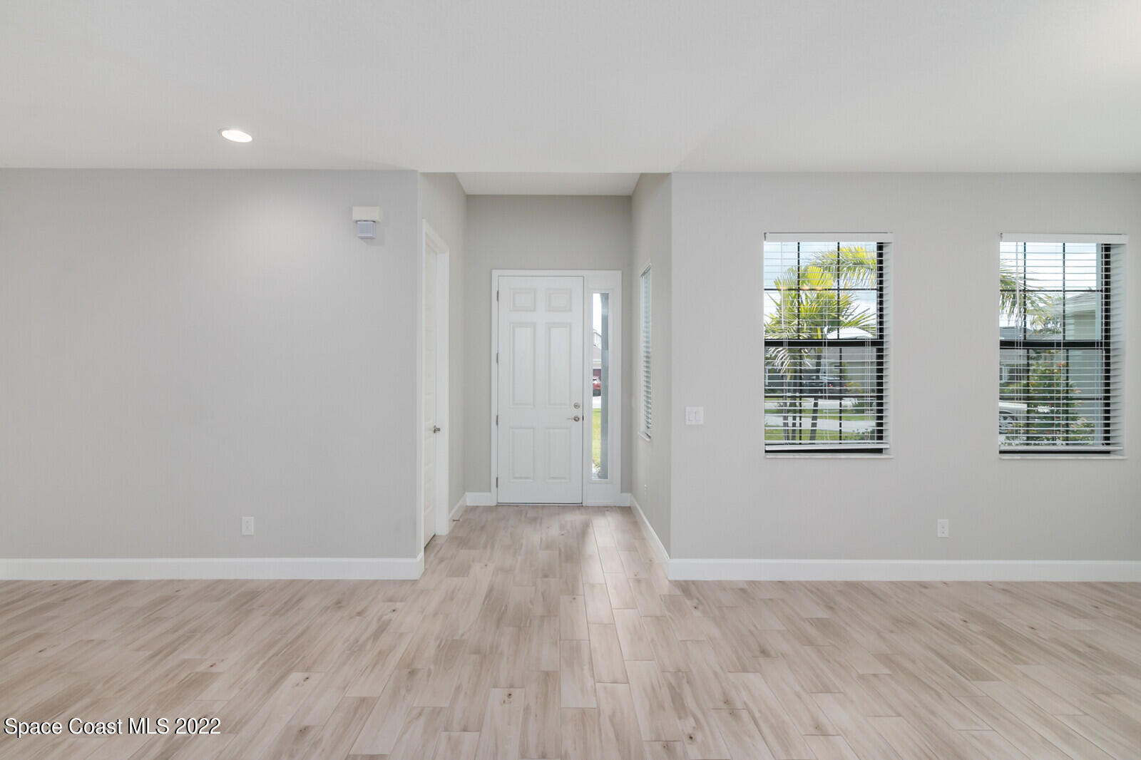 3289 Ribbon Grass Drive Melbourne, FL 32940 - Photo 3 of 58 a view of an empty room with wooden floor and a window