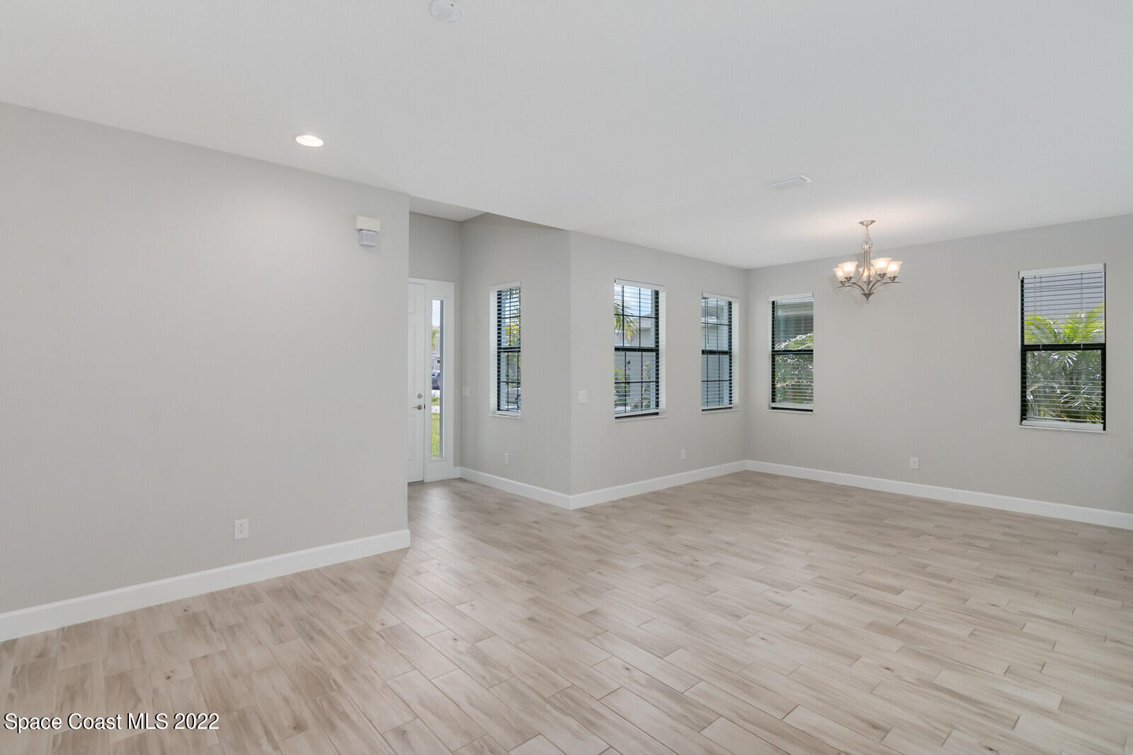 3289 Ribbon Grass Drive Melbourne, FL 32940 - Photo 4 of 58 wooden floor in an empty room with a window