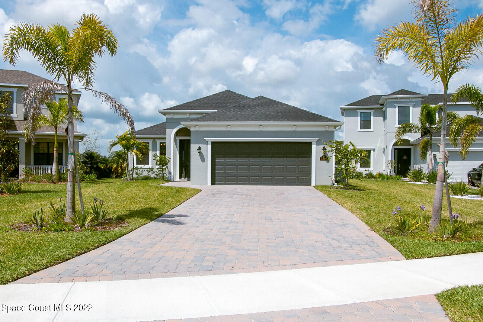3289 Ribbon Grass Drive Melbourne, FL 32940 - Photo 58 of 58 a front view of a house with a yard and garage